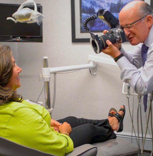 Dr. Mohr taking photo of smiling patient